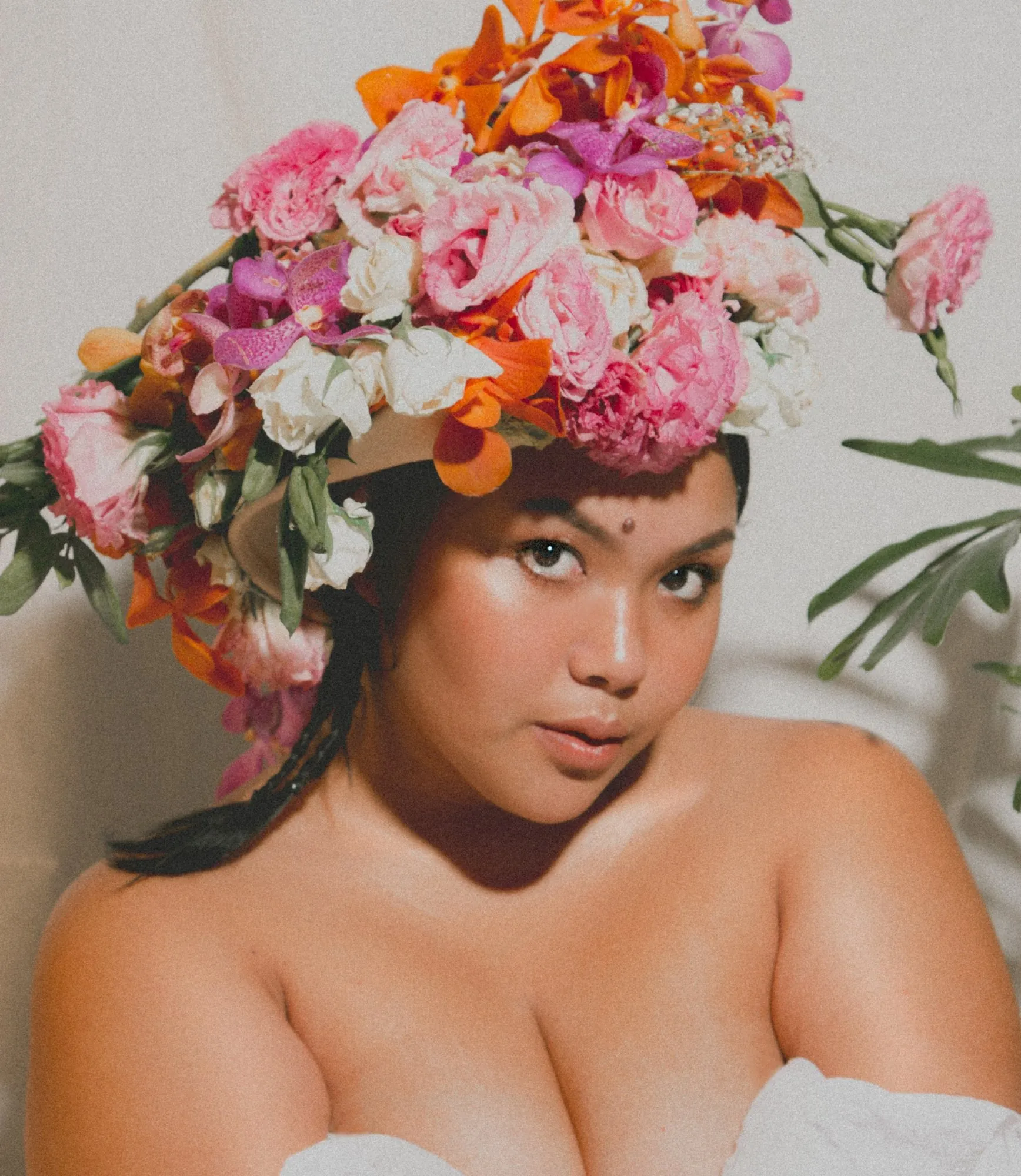 Thurees in a crown of pink and orange flowers