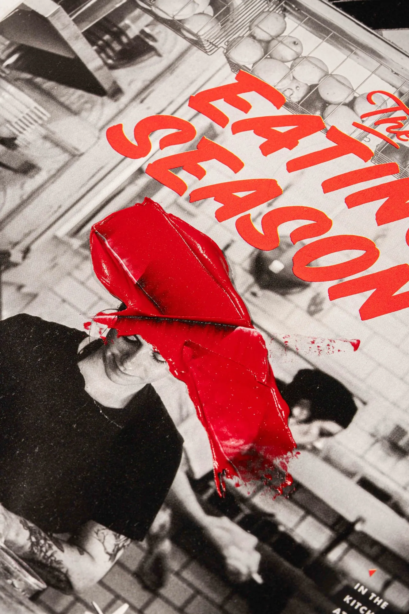 A red lipstick smeared across a black-and-white food magazine page