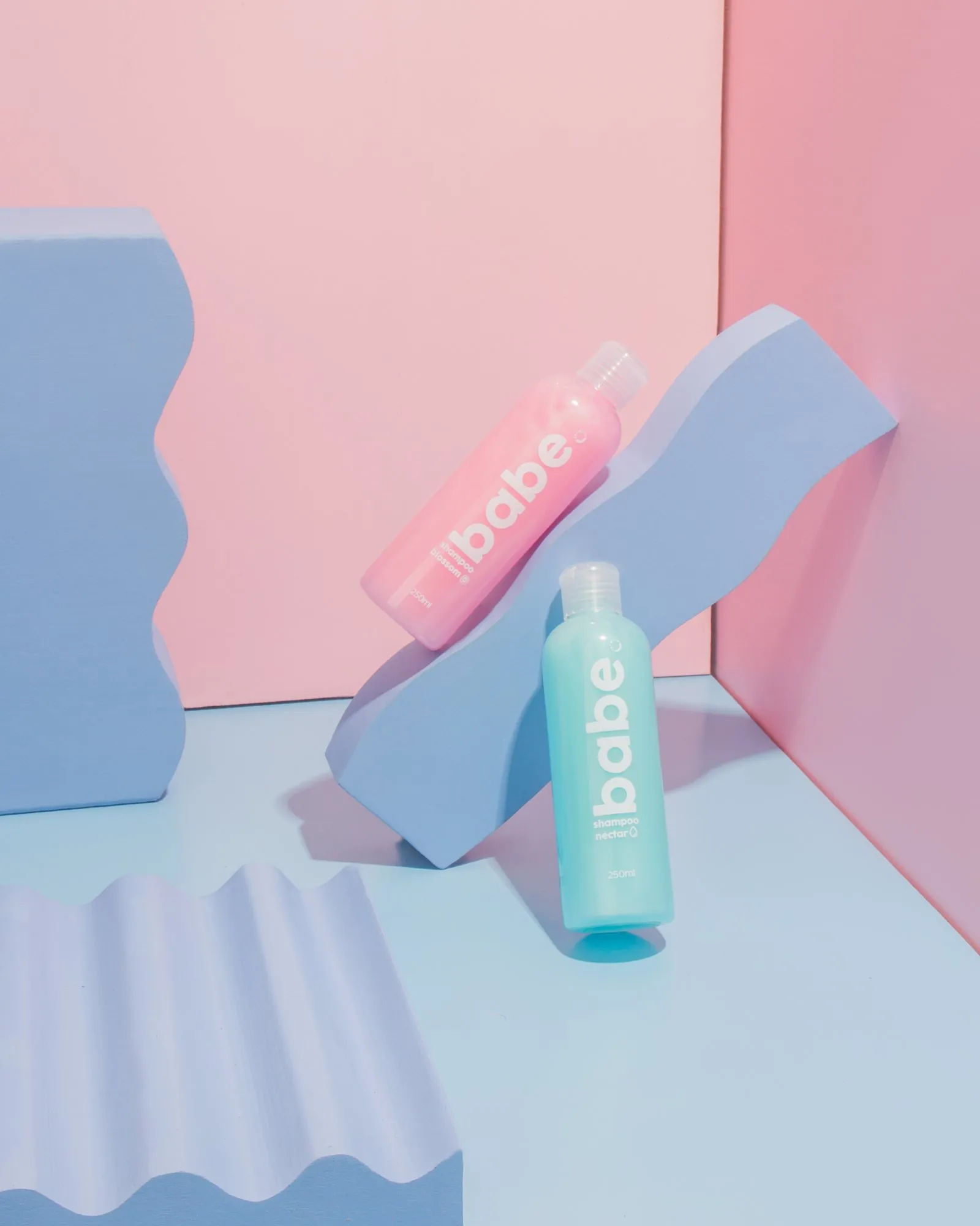 Babe Formula bottles on wavy pastel blocks