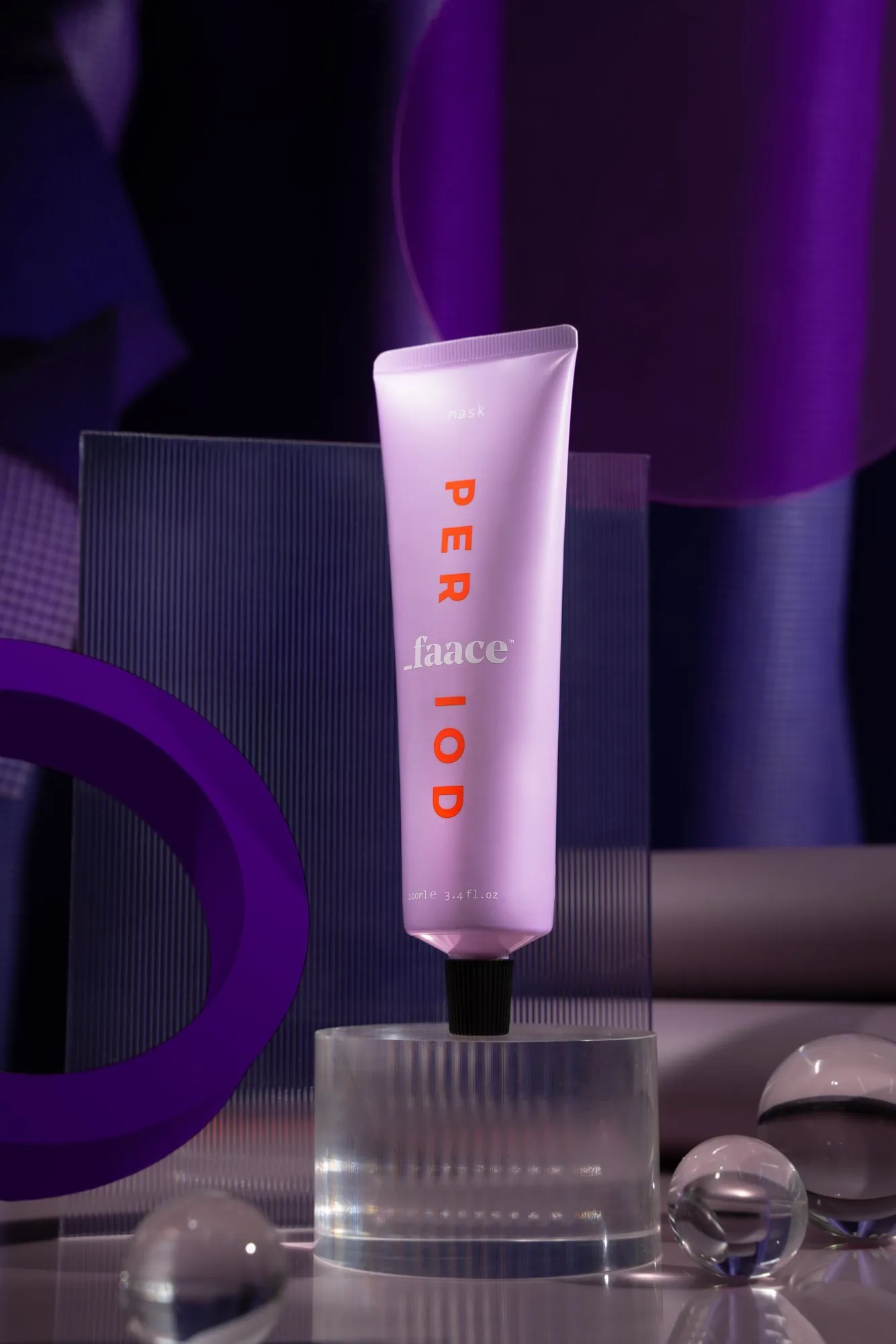 A lilac Faace tube on a glass block in purple light