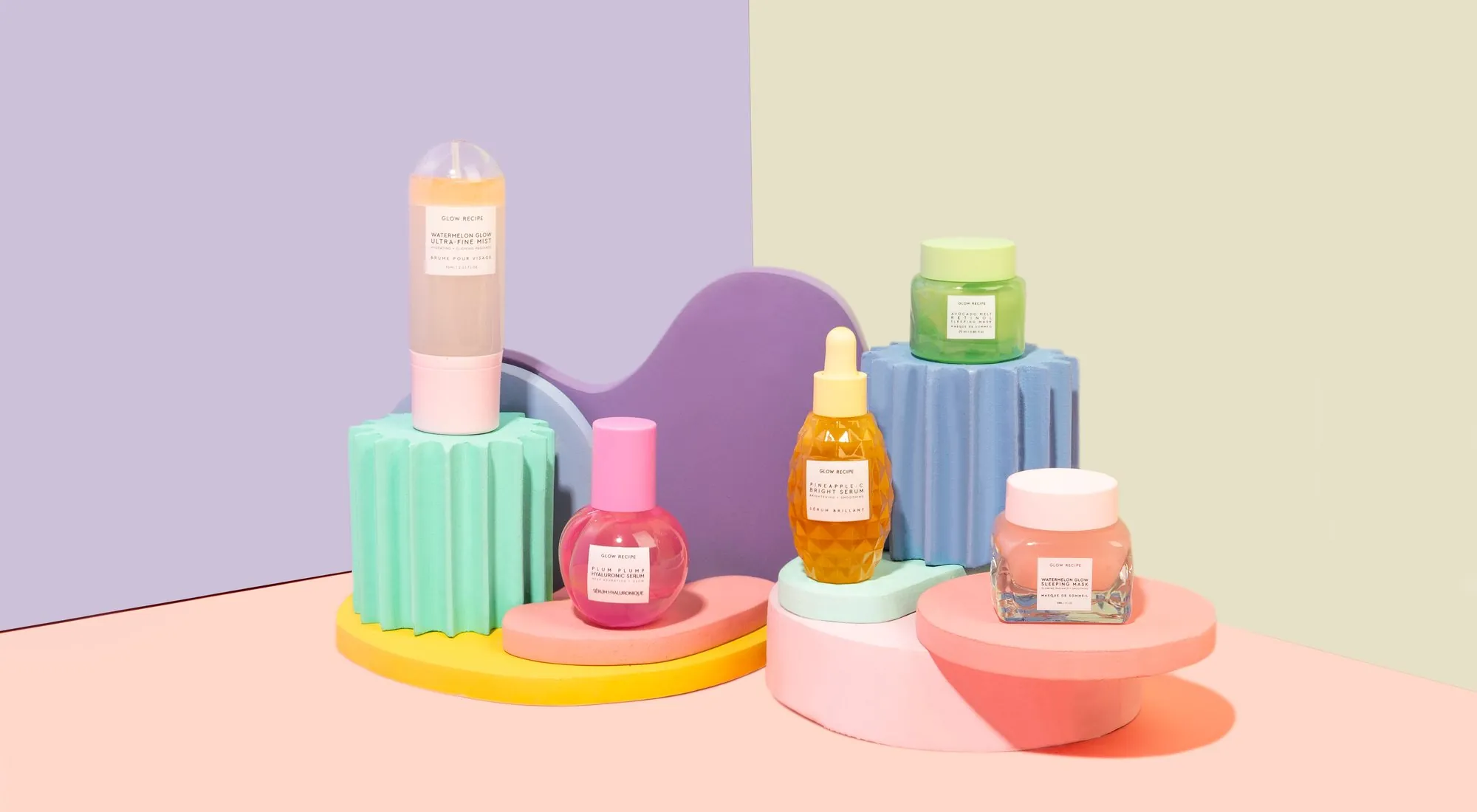 Glow Recipe jars lined up on pastel plinths