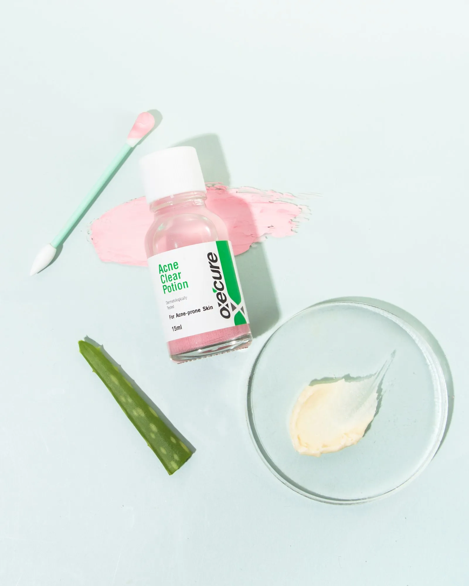 An Oxecure acne serum with aloe and a swab on mint